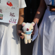 Secondary school students hold a plush toy in solidarity with a female protester who was earlier allegedly shot in the eye by police.